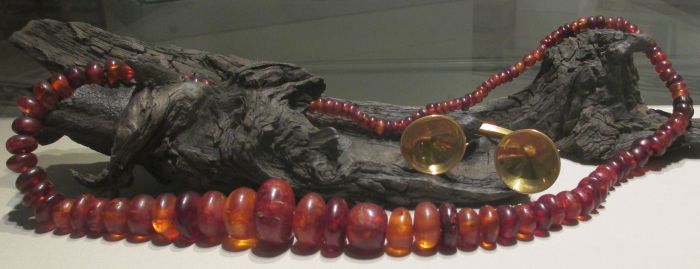 A Bronze-Iron |Age gold dress fastener and an amber bead necklace (800 - 700 BCE) National Museum Ireland Archaeology Dublin