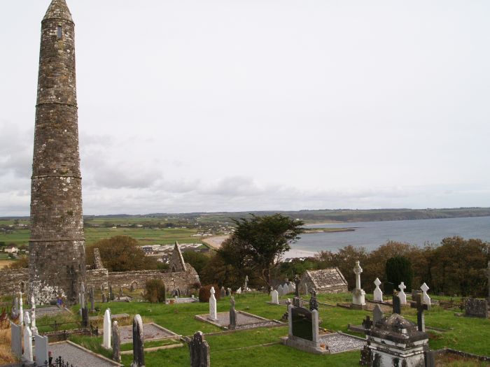 The round tower, graveyard and below them the ruins of Ardmore Cathedral. The round tower and cathedral were built as part of a political struggle between the Bishops of Ardmore and Lismore and Bishop Eugene of Ardmore was politically more successful in his dealings with the new Anglo-Norman lords. Ardmore, Co. Waterford, Ireland