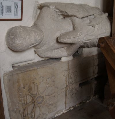 The late 13th century effigy of praying knight in chain mail, below this is a foliated cross and sword typical of a 12th century tomb.
