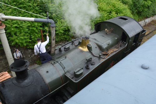Filling up the steam locomotive with water from a good old fashioned railway water crane at Parkend station Dean Forest Railway Gloucestershire England