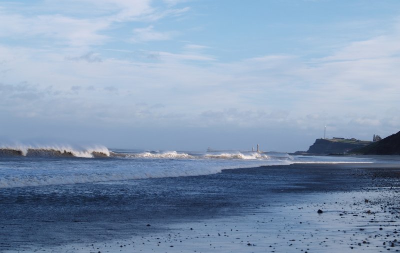 8. Sandsend beach looking towards Whitby, North Yorkshire, the ruins of Whitby Abbey are on the middle right.