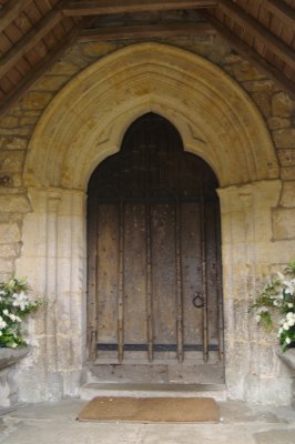 The wonderfully stone carved trefoil shaped 13th century south entrance door with its 'much repaired' 15th century wooden door