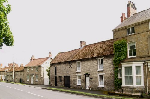 A row of old houses on the main road through Middleton. Pear Tree Farm is on the right.