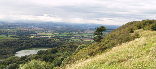 View across Lake Goremire, the Vale of York and across to the Yorkshire Dales from the limestone escarpment near Sutton Bank, North Yorkshire
