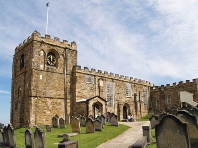 The tower of St Mary's Church, Whitby. The main entrance (centre) is paralleled by the Norman south door to its right.