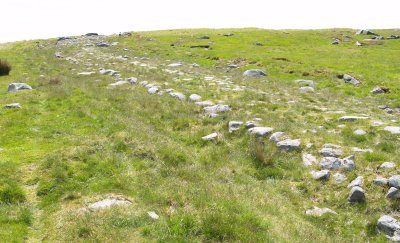 The original curb stones can be seen quite clearly as a neat line on the left of the road.
