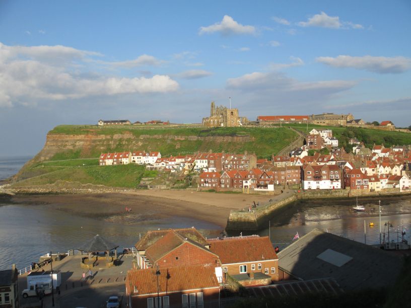 Looking across the lower Whitby harbour to the oldest quay/wharf and above it St Mary's Church and Whitby Abbey