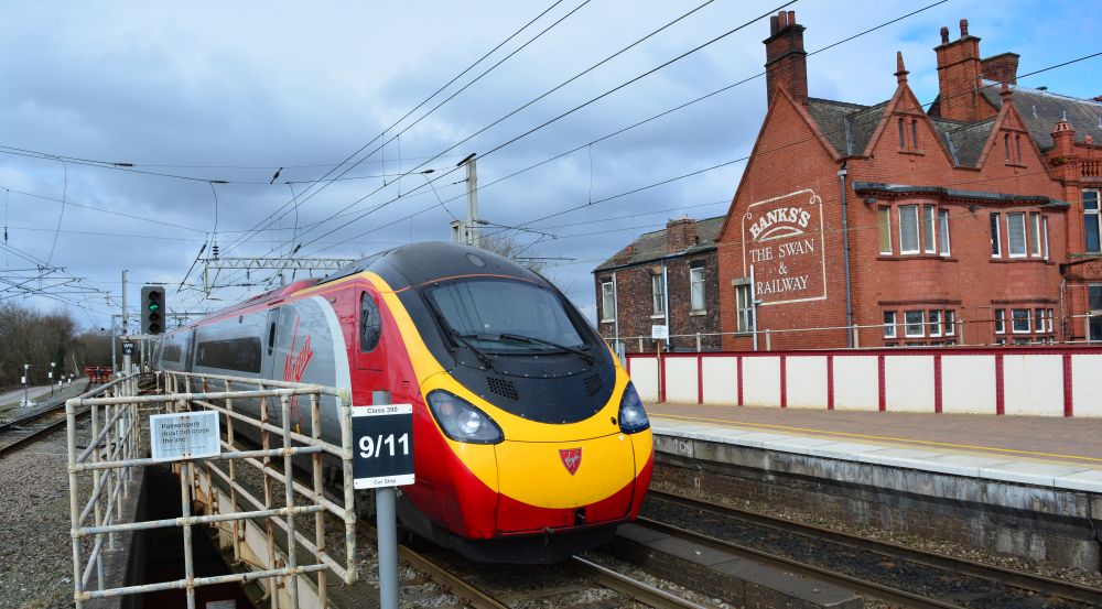trainspotting at Wigan North Western Station Virgin trains London Euston to Glasgow Central service leaving Wigan North Western station, EMU class 390 390117. Compare the same scene in the days of steam above!