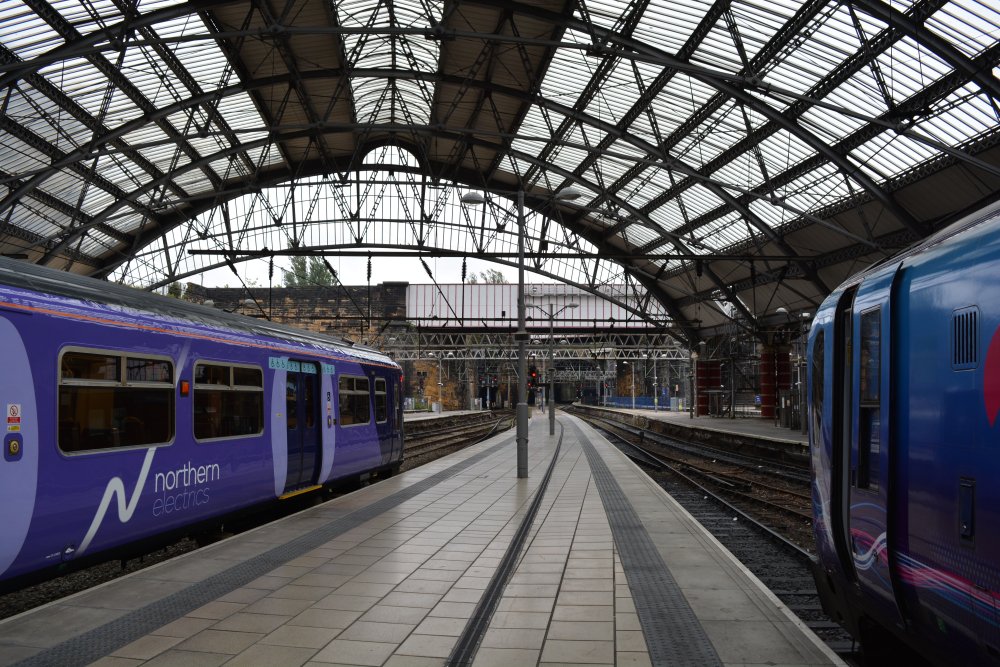 Northern Rail and TransPennine Express services next to each other under the great arches of Lime Street Station, Liverpool