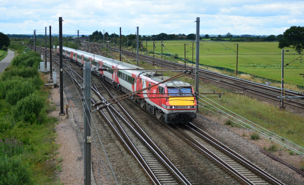 Trainspotting Colton Junction Class 91 electric locomotive 91124 heading the LNER 0906 service from London Kings Cross to York trainspotting Colton Junction footbridge