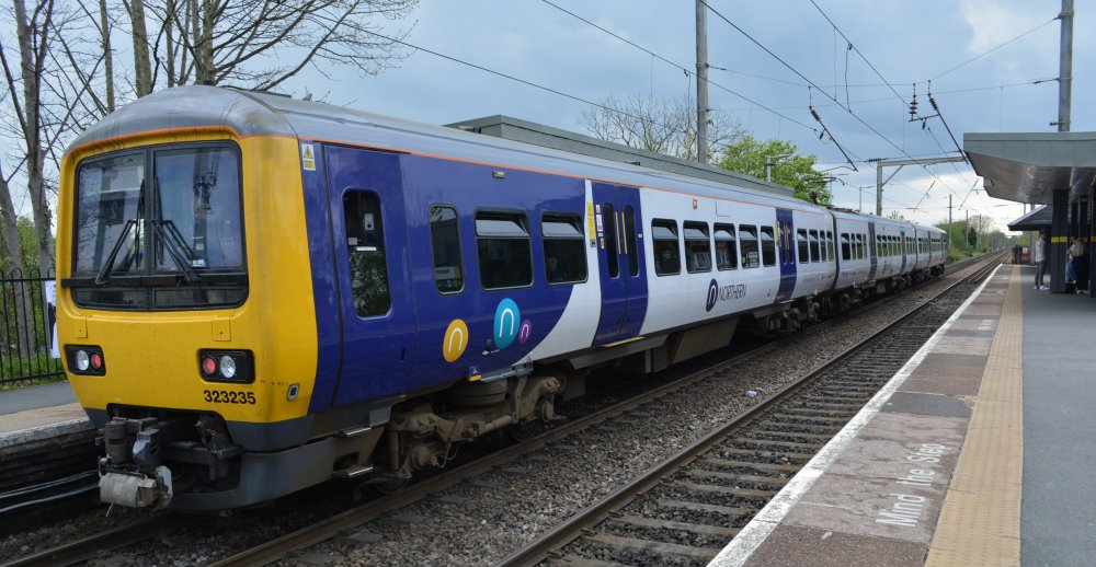 Hunslet built electrical multiple 3-car unit EMU Class 323 323235 at Newton-le-Willows station with a Northern Rail service from Manchester to Liverpool (April 2023)