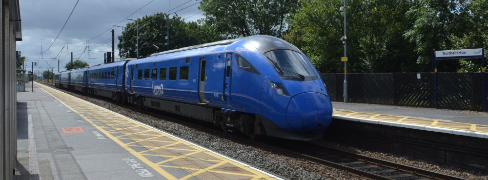 A Class 803 express EMU speeds north through Northallerton station with a lumo Kings Cross to Edinburgh service (trainspotting July 2023).